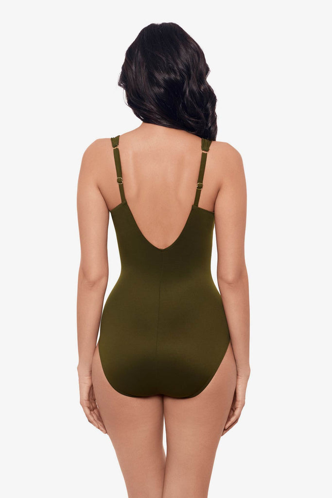 Woman facing away wearing a nori green one-piece swimsuit with a deep scoop neck