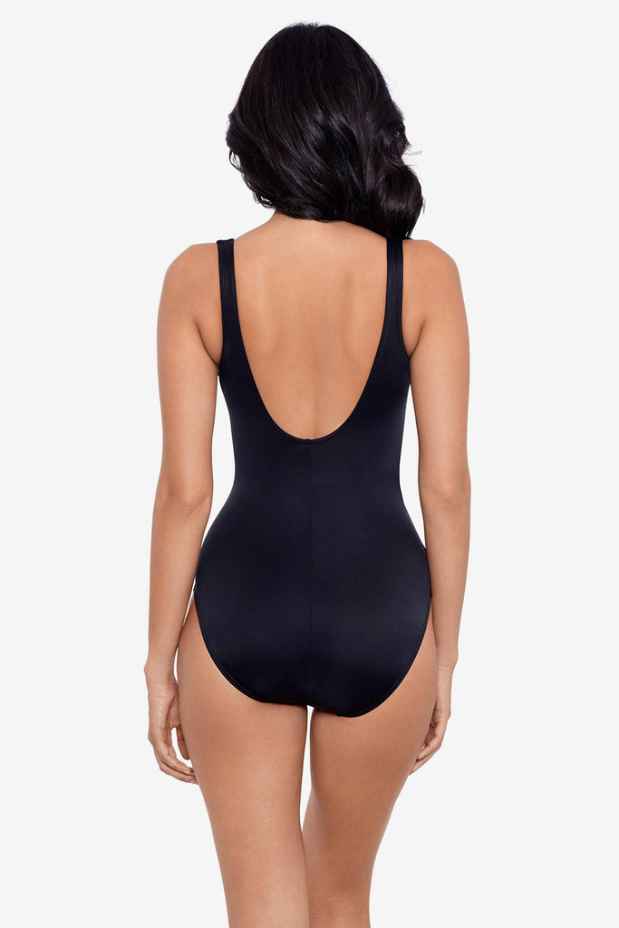 Woman faced away wearing a black one-piece swimsuit