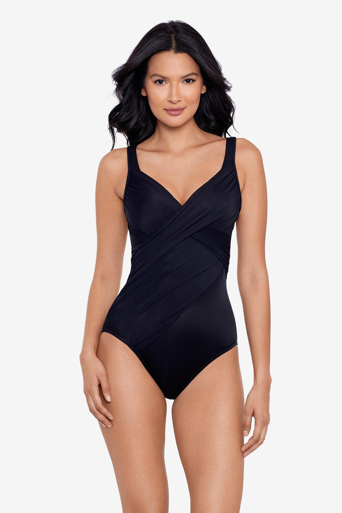 Woman wearing a black one-piece swimsuit with sweetheart neckline