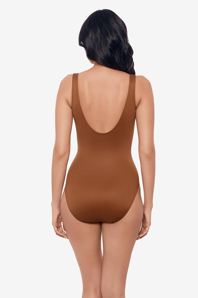 Woman turned away wearing a brown one piece swimsuit