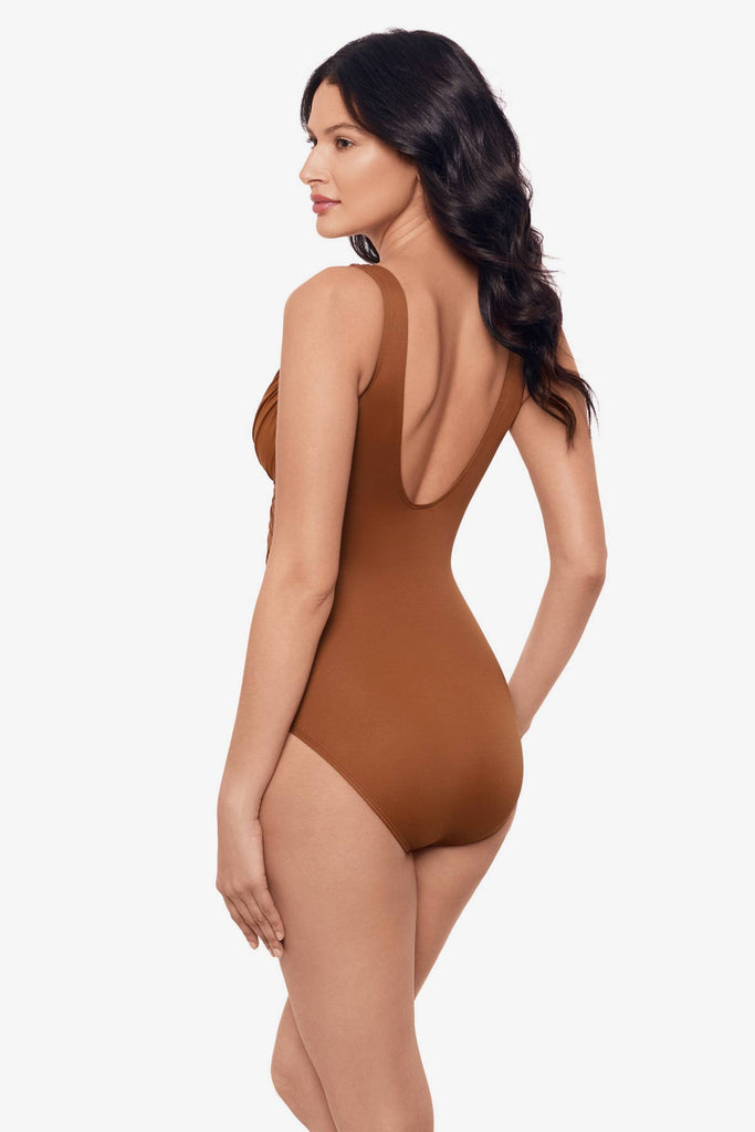 Woman facing left to show side detail of the one-piece swimsuit