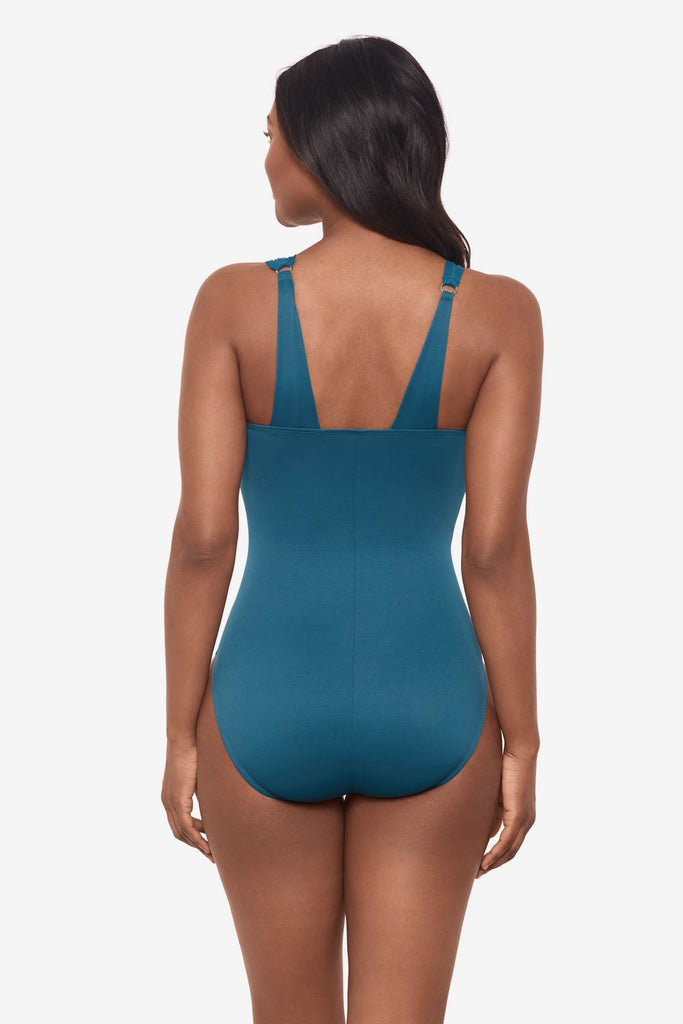 Woman facing away wearing an aegean blue one-piece swimsuit 