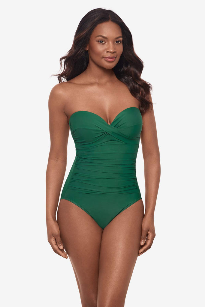 Woman wearing a strapless malachite green one-piece swimsuit with wrap texture