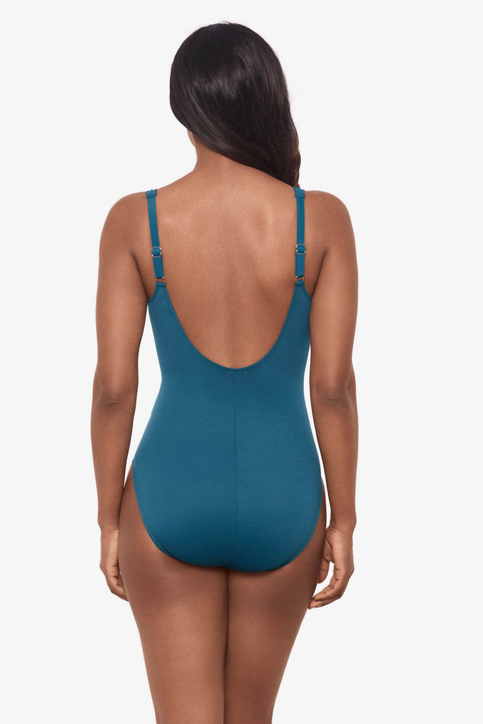 Woman facing away wearing an aegean blue one-piece swimsuit 