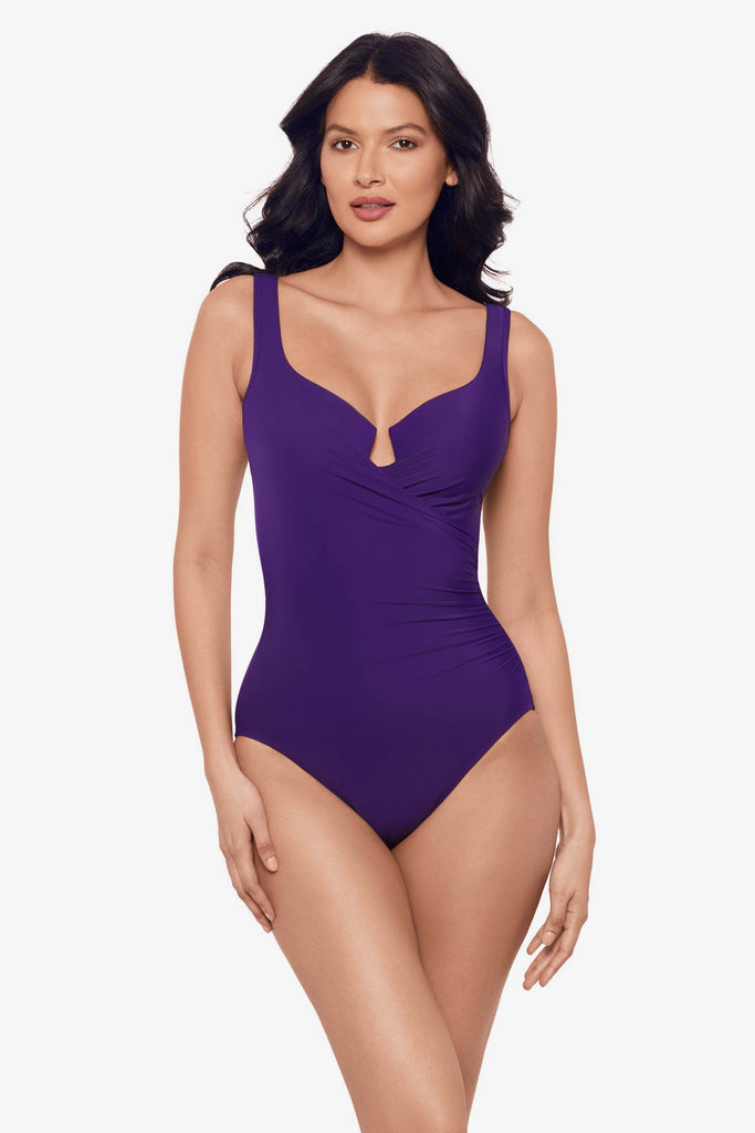 Woman wearing a mulberry purple one-piece swimsuit with a sweetheart neckline