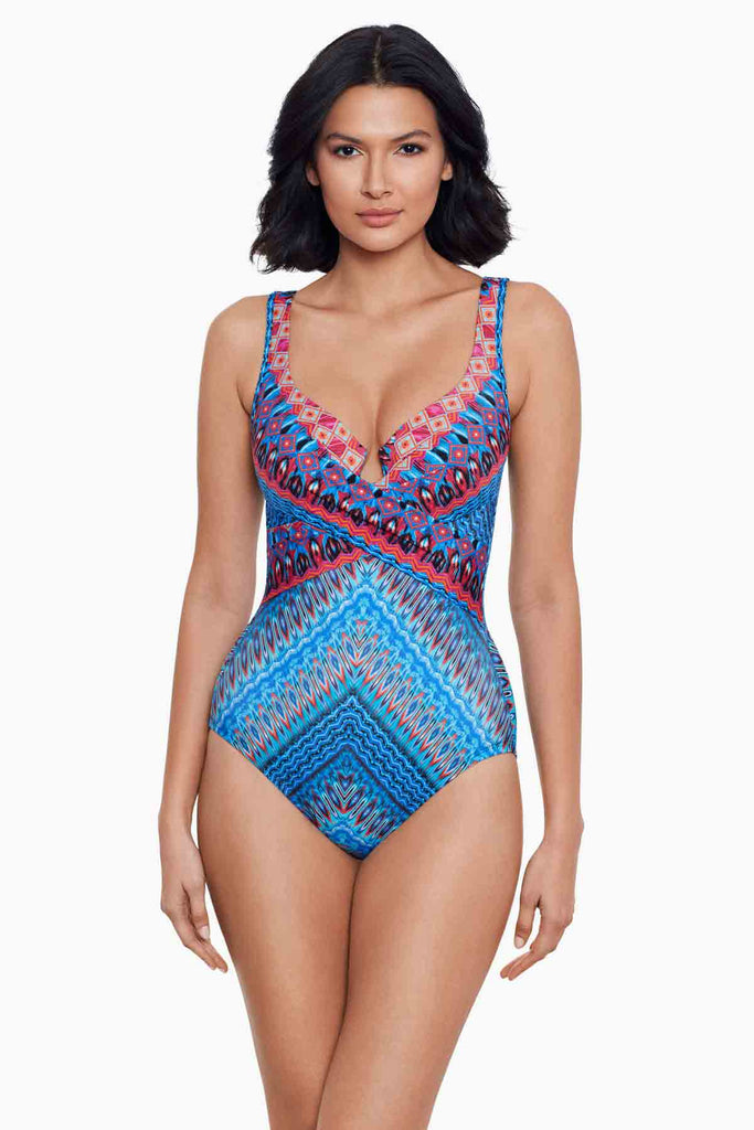 Woman wearing a printed one piece swim suit.