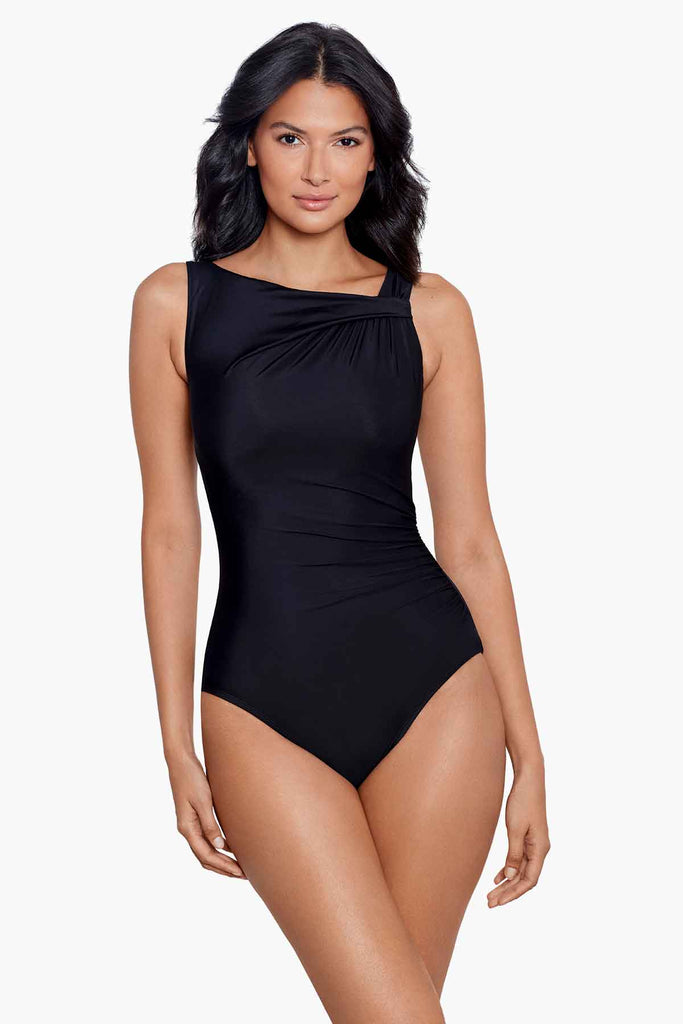 Woman wearing a black one-piece swimsuit with a high neckline