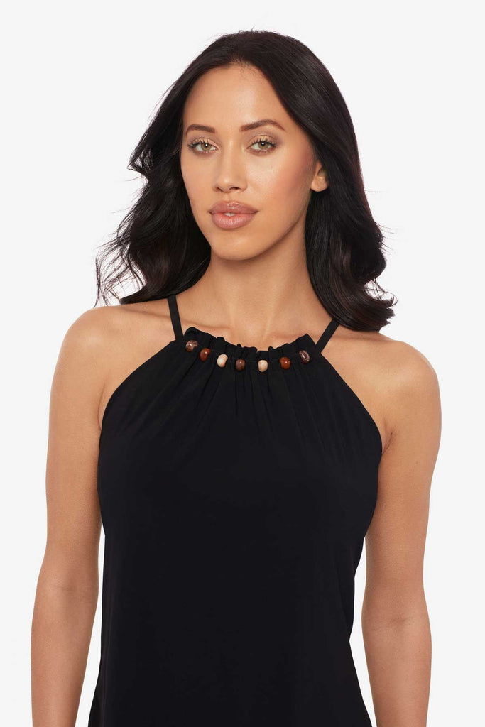Close up of woman wearing a black tankini top with beading along the neckline