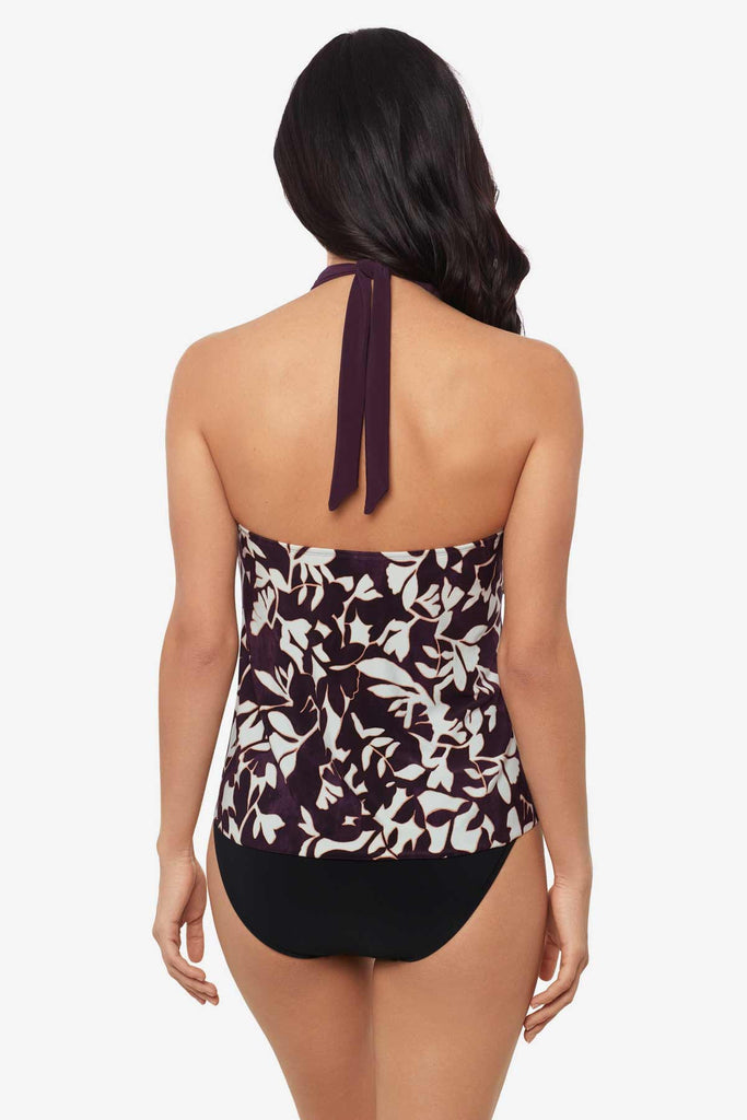 Woman tuned away wearing a multicolor tankini top with white flowers