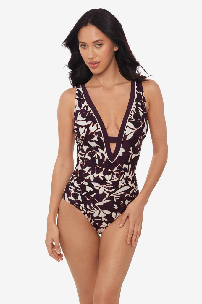 Woman wearing a multicolor one-piece swimsuit with a deep v-neck