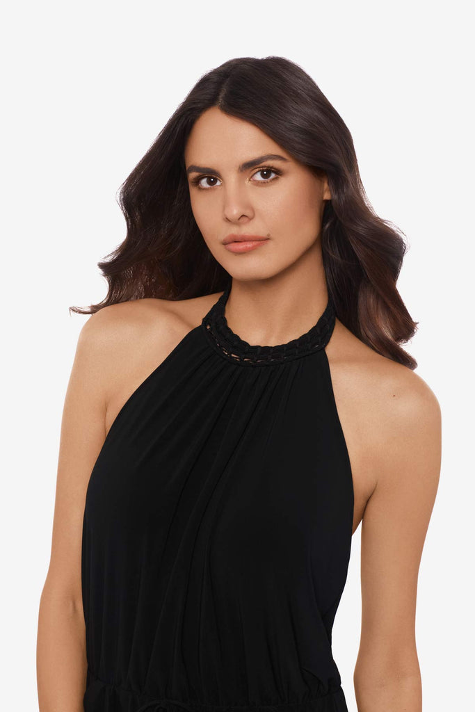 Close up of woman wearing a black swim romper with a high neckline