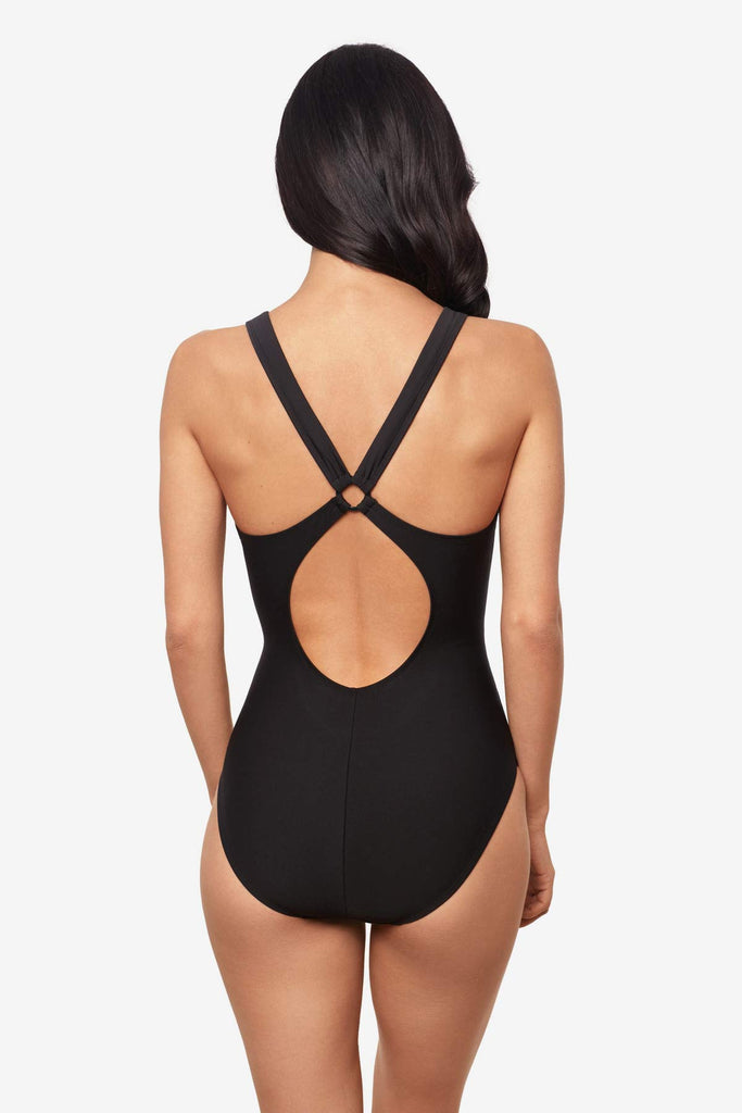 Woman facing forward Woman wearing a black one-piece swimsuit with an X back