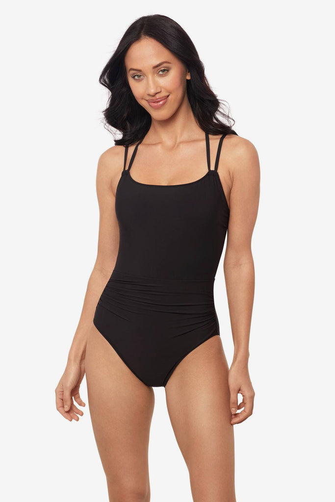 Woman wearing a black one-piece swimsuit with double straps