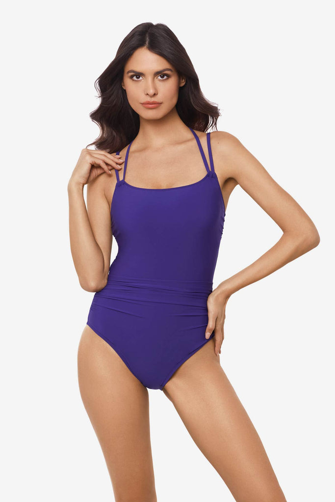 Woman wearing a passion purple one-piece swimsuit with double straps