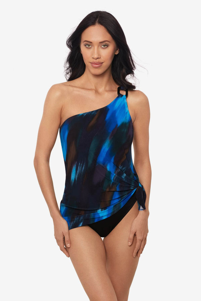 Woman wearing a multicolor swim dress with an asymmetrical cut