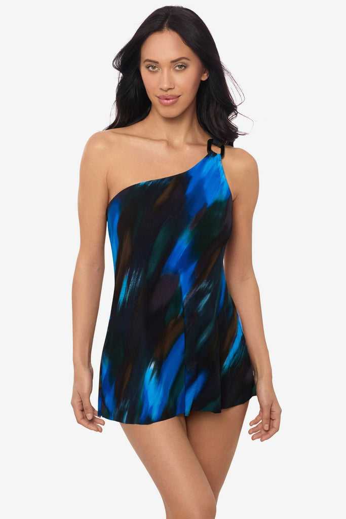 Woman wearing a multicolor swim dress with an asymmetrical cut and untied on the side