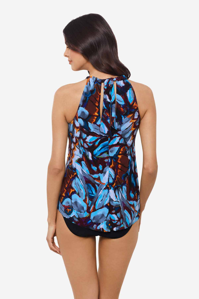 Woman facing away wearing a multicolor tankini top with abstract flowers