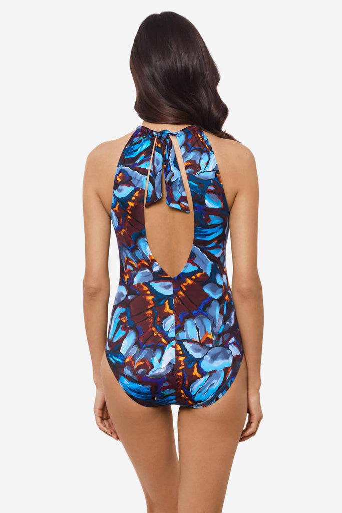 Woman facing away Woman wearing a multicolor one-piece swimsuit 