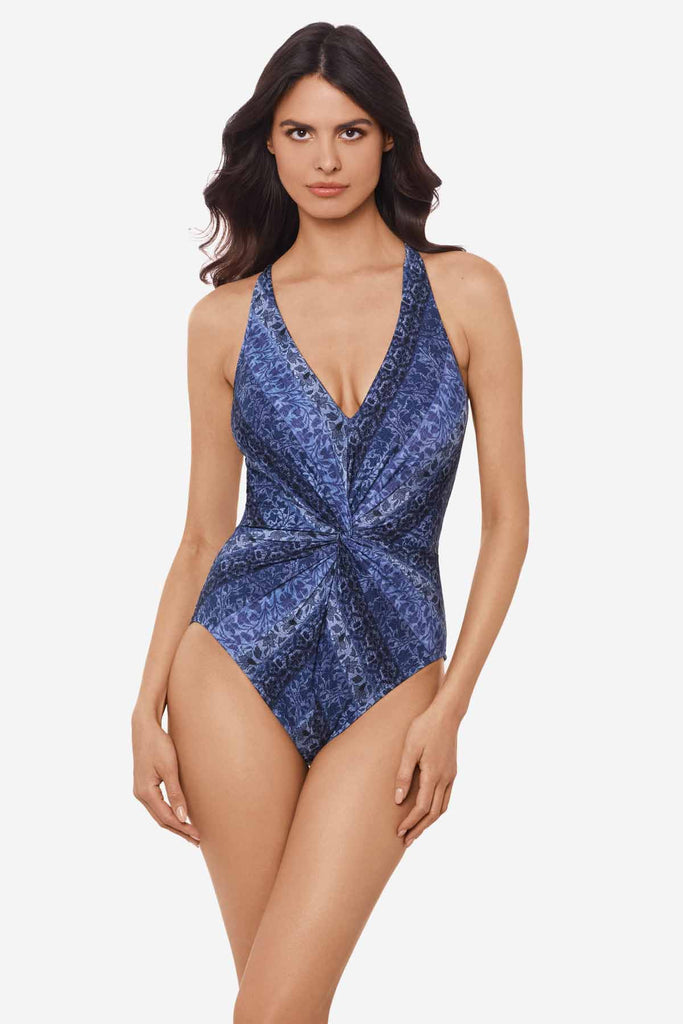 Woman wearing a multicolor one-piece swimsuit with a wrap detail