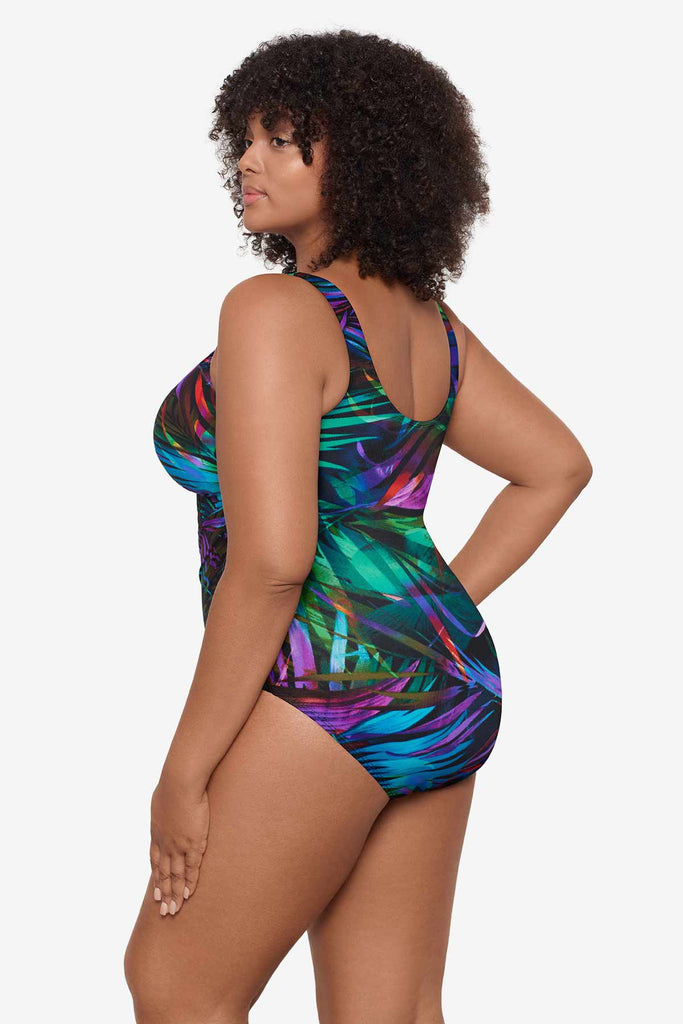 Woman facing left to show detail of one-piece swimsuit