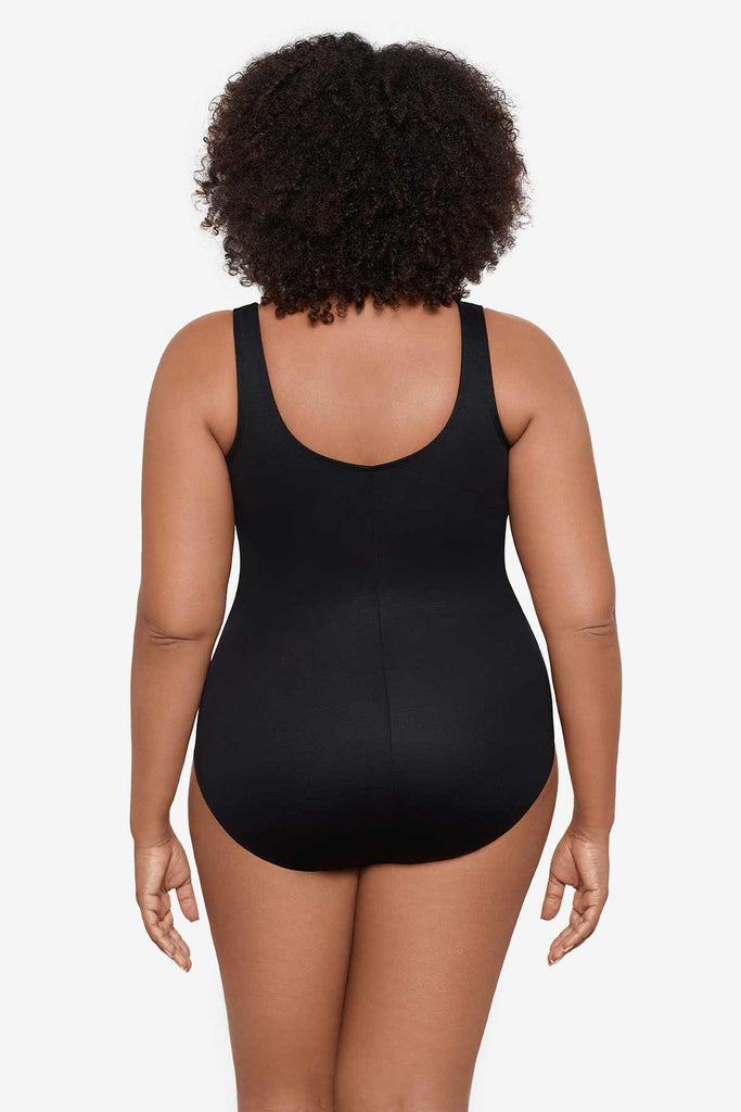 Woman facing away to show off back of the one-piece swimsuit