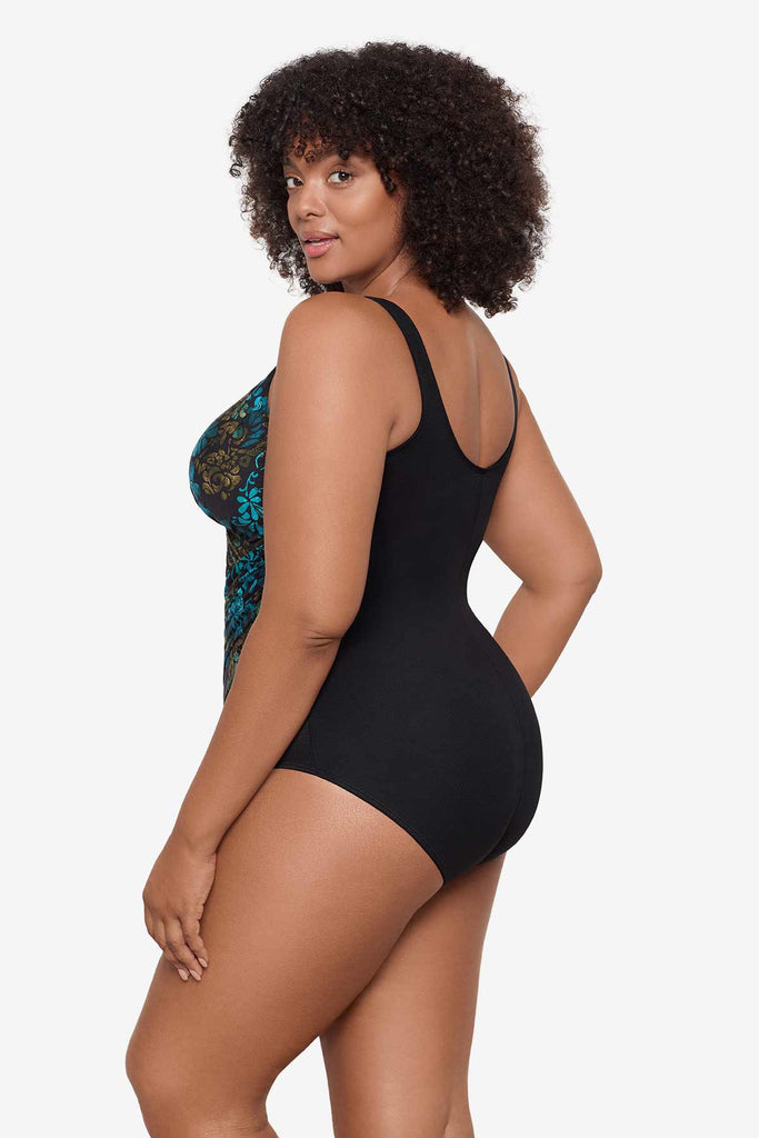 Woman turned to the side to show detail of the one-piece swimsuit