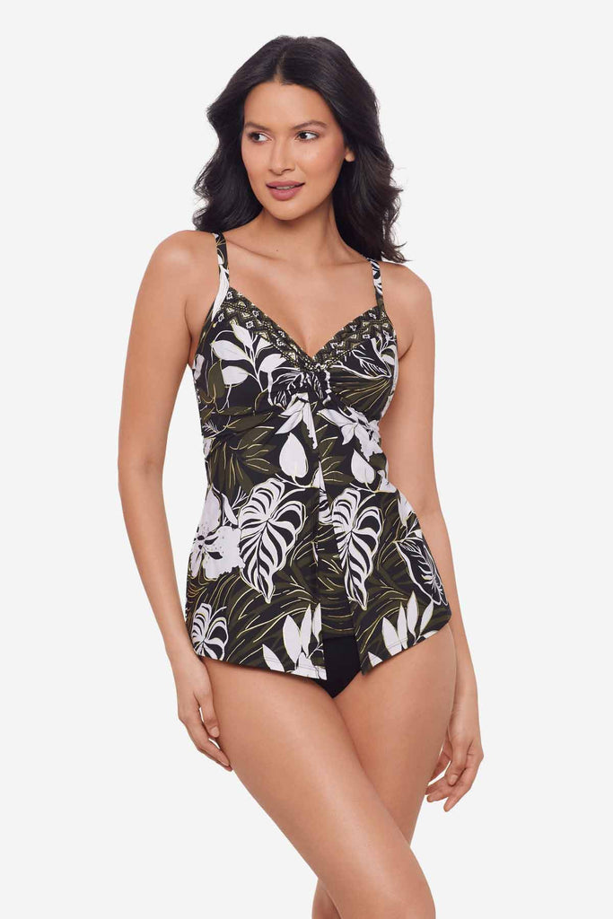 Woman wearing a multicolor tankini top with large white palm leaves
