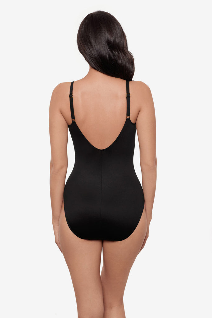 Woman turned away wearing a black one-piece swimsuit