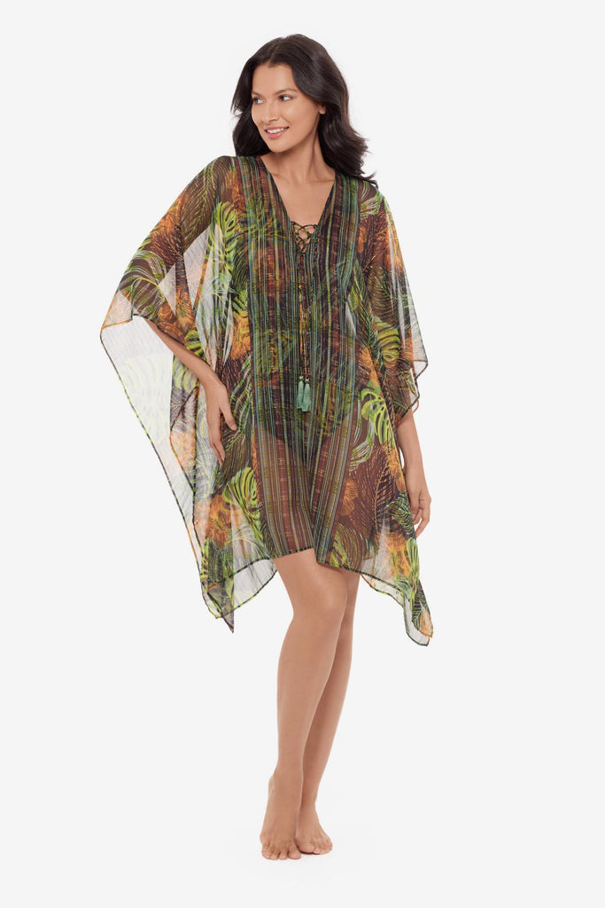 Woman wearing a palm leaf printed caftan swim cover up