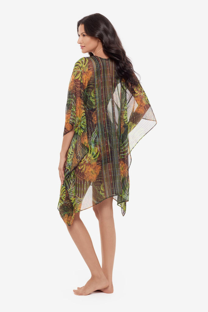 Woman turned left wearing a palm leaf printed caftan swim cover up