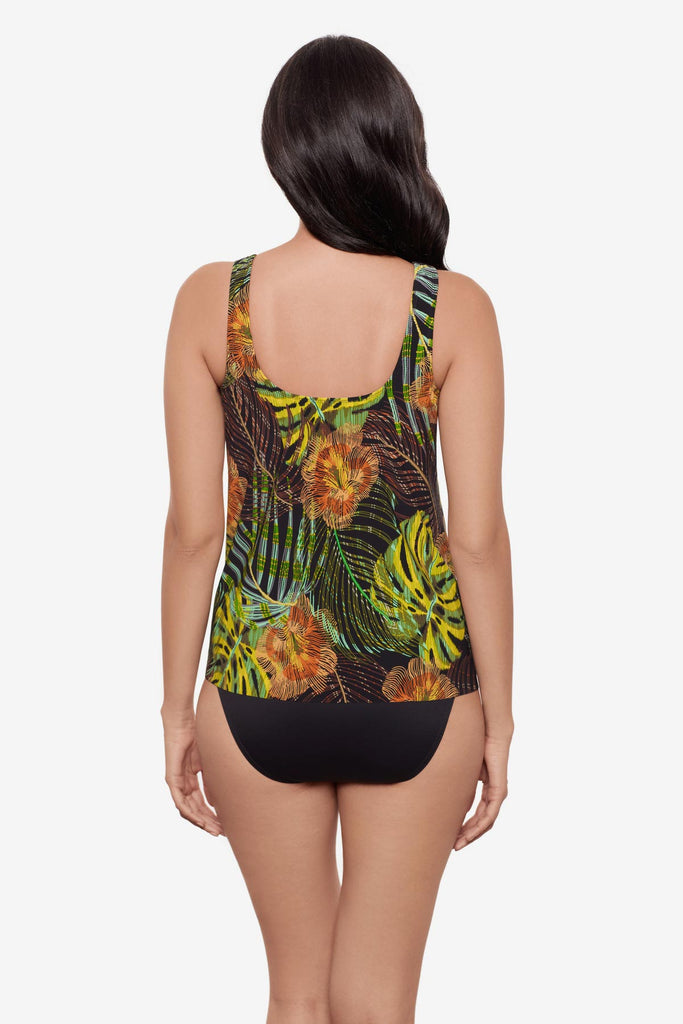 Woman turned away wearing a multicolored palm leaf printed tankini top