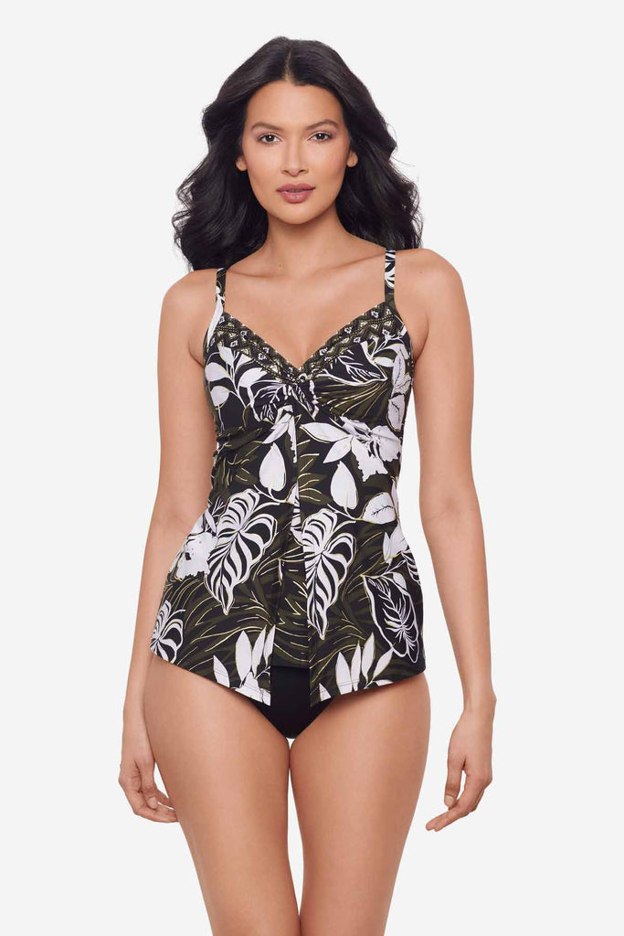 Woman wearing a multicolor tankini top with large white palm leaves