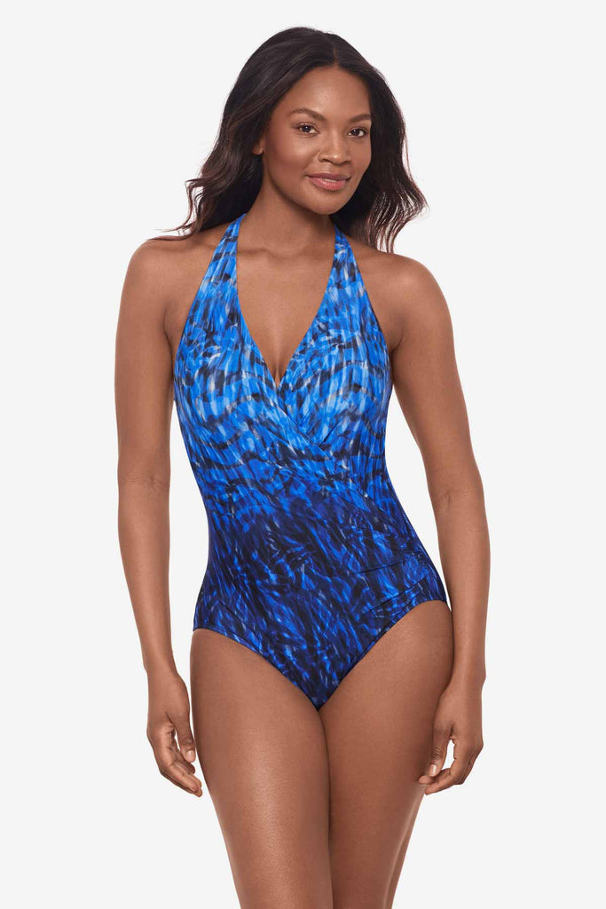 Woman wearing a blue one-piece swimsuit with an ombre effect