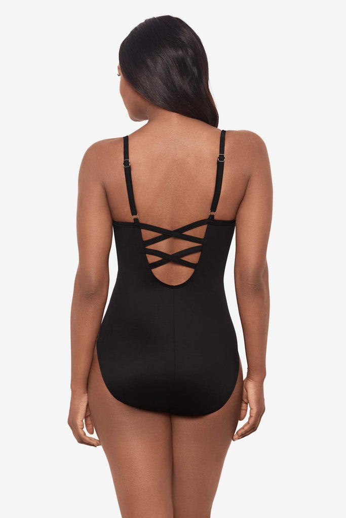 Woman turned away showing criss-cross back detail on one piece suit