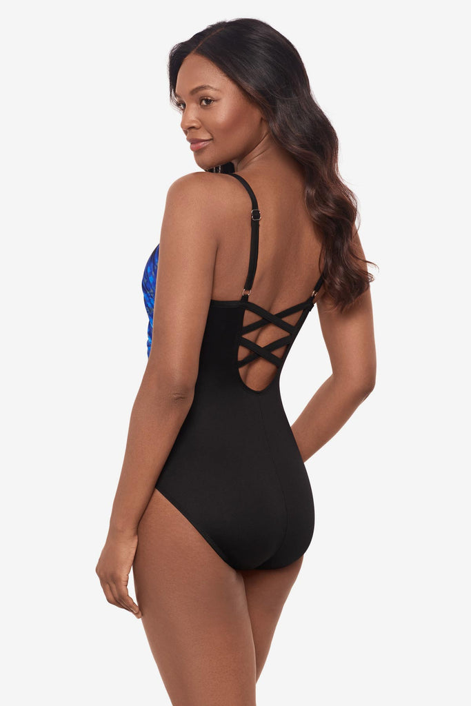 Woman turned to the side to show the detail of the one-piece swimsuit