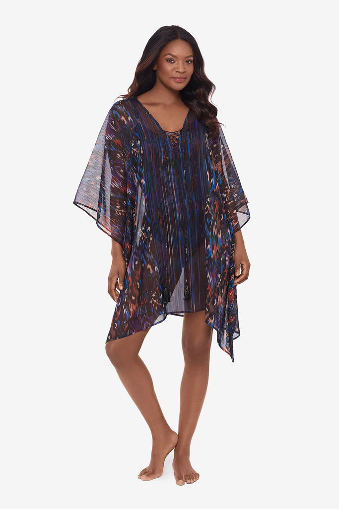 Woman wearing a multicolored sheer swimsuit cover up