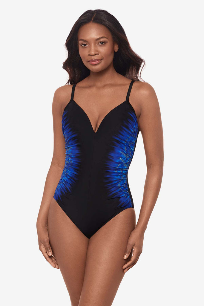 Woman wearing a black swimsuit with blue on each side