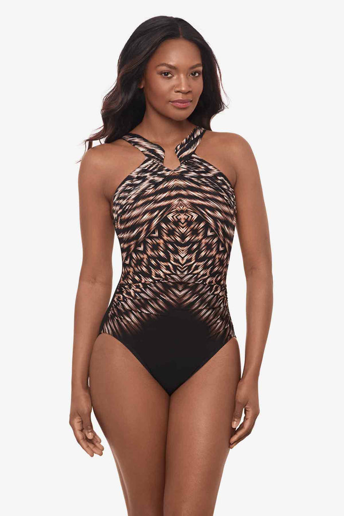 Woman wearing a one-piece swimsuit with a multicolor pattern and high neckline