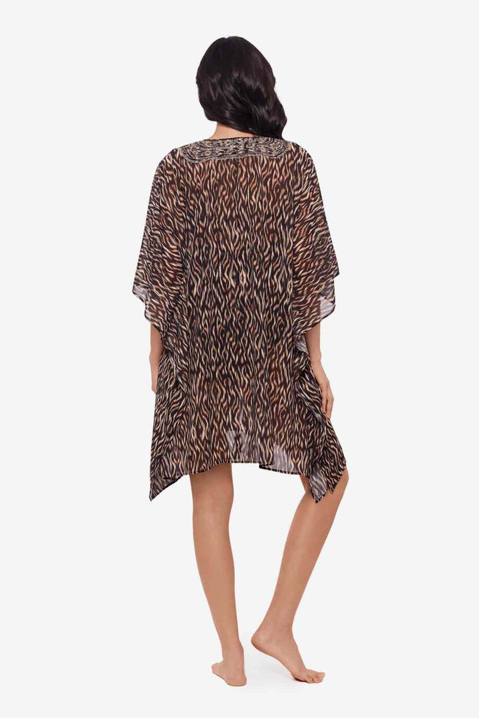 Woman facing away to show detail of multicolor print swimsuit cover up
