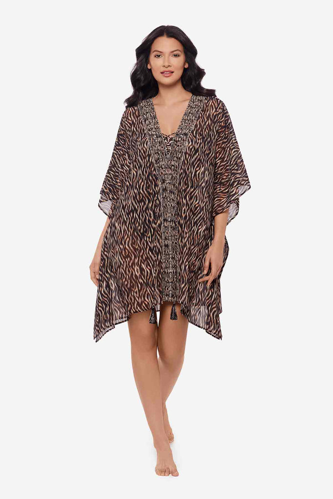 Woman wearing multicolor print swimsuit cover up with tassels