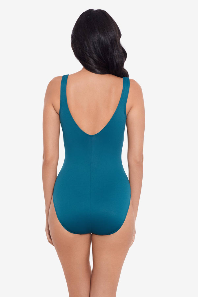 Woman facing away wearing an agean blue one-piece swimsuit 