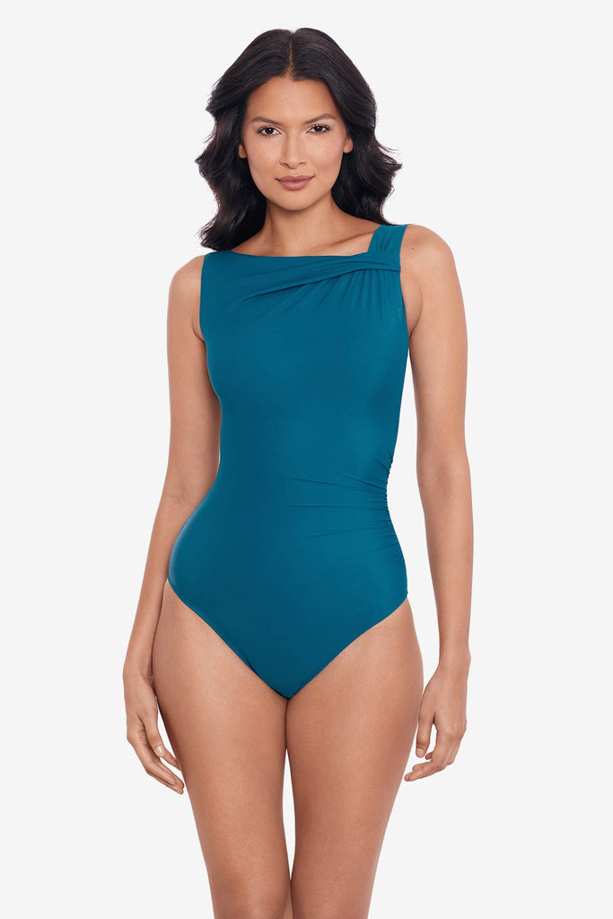 Woman wearing an aegean blue one-piece swimsuit with a high neckline