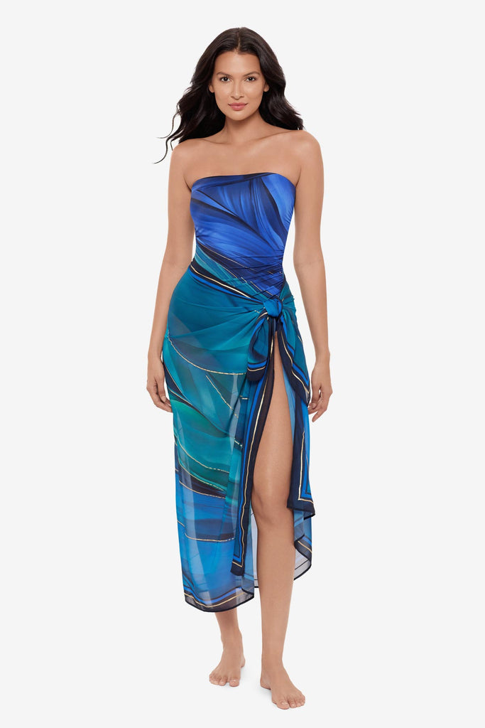 Woman wearing a multi-blue swim cover up with matching swimsuit