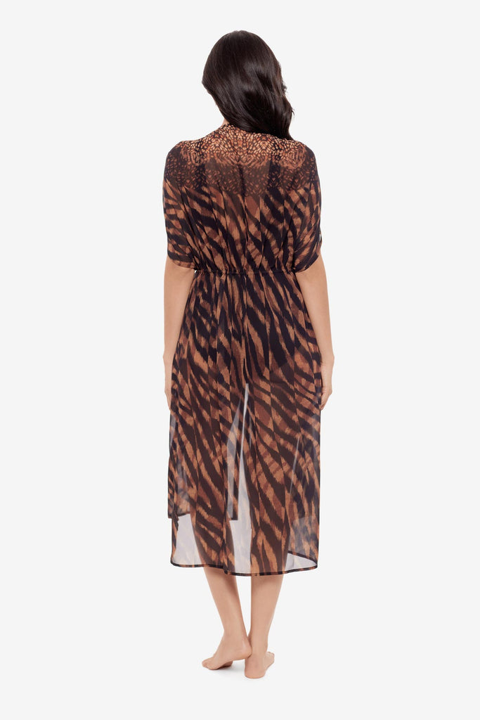 Woman turned away wearing a black and brown beaded kimono style swim cover up