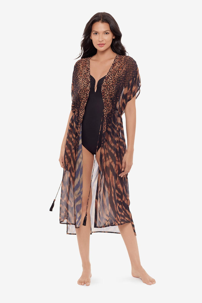 Woman wearing a black and brown beaded kimono style swim cover up