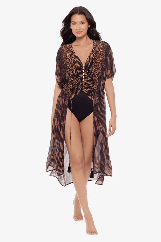 Woman wearing a black and brown beaded kimono style swim cover up