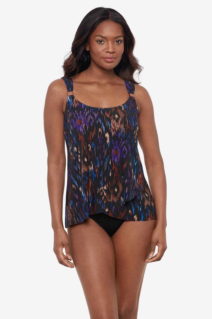 Woman wearing a multicolored tankini swim top with detailing on the straps