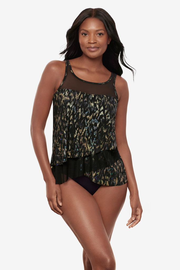 Woman wearing a black sparkly tankini top with mesh cutouts throughout
