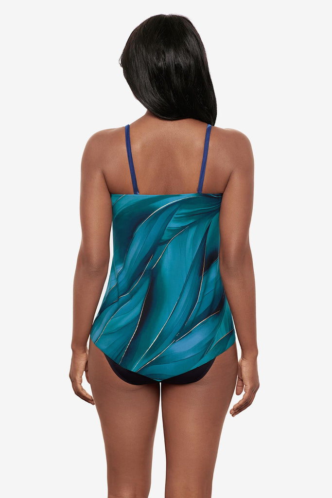 Woman wearing a multi-blue bandeau tankini top with gold detail