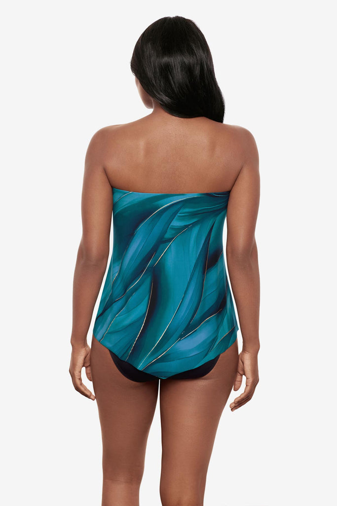 Woman turned away wearing a multi-blue bandeau tankini top with gold detail